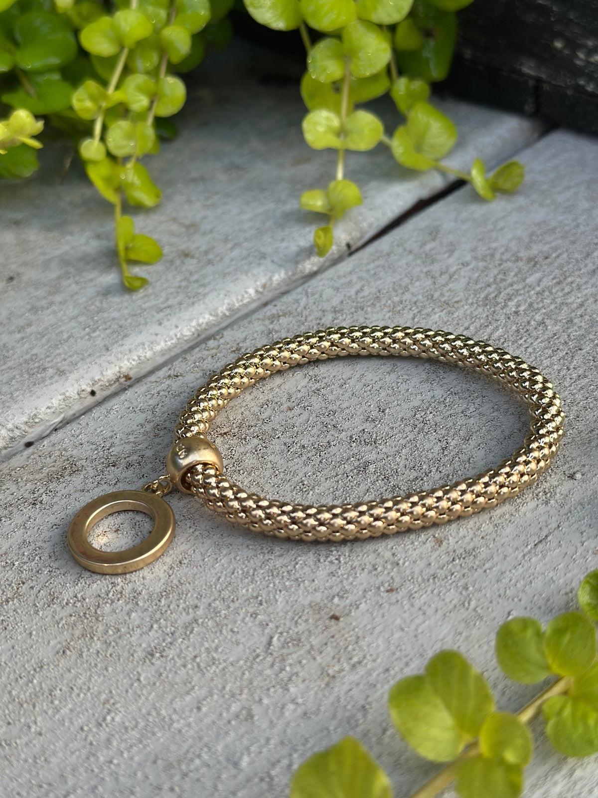 Gold twisted bead bracelet with O-ring charm
