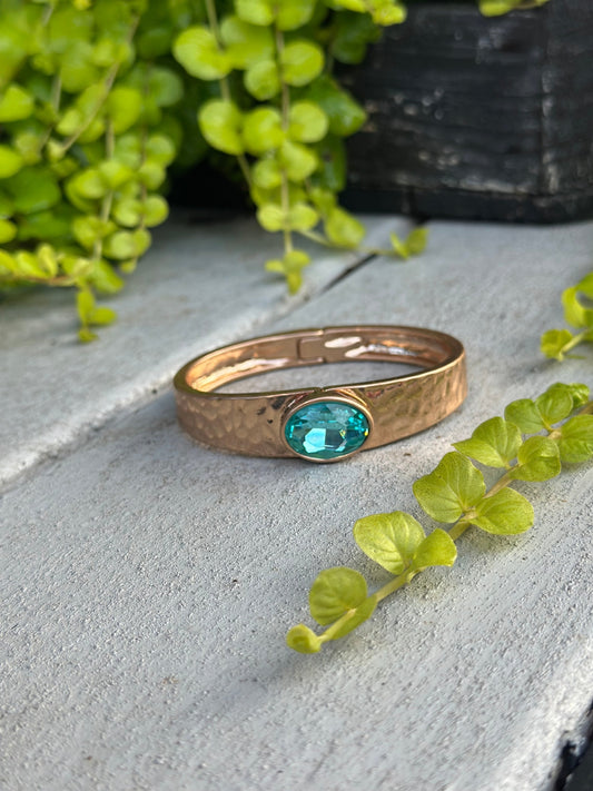 Gold hammered cuff with blue stone