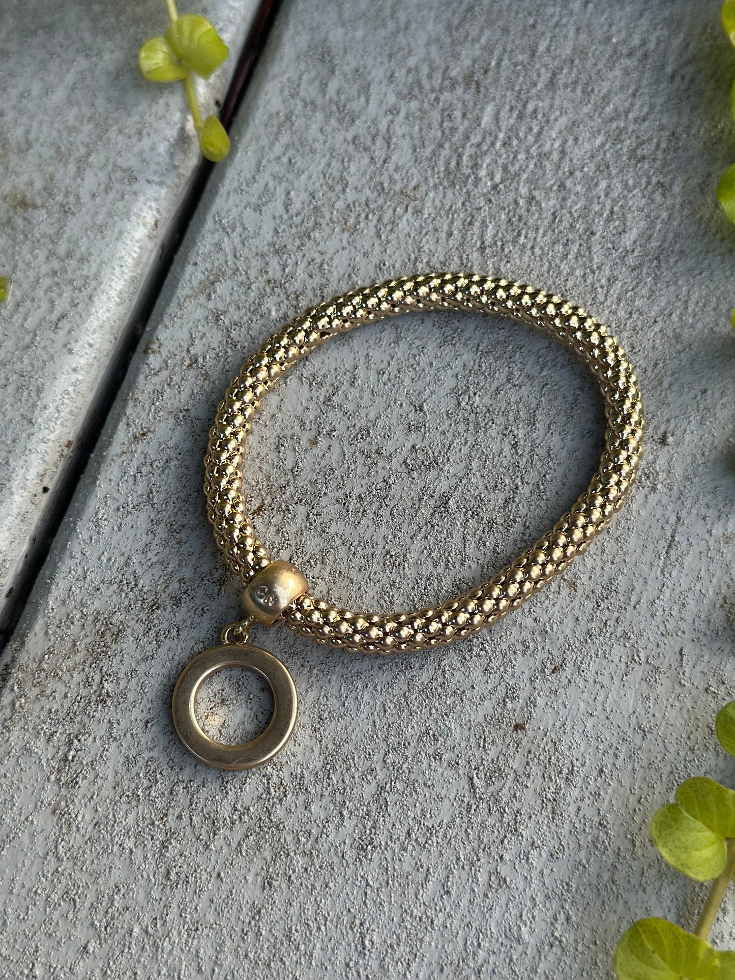 Gold twisted bead bracelet with O-ring charm