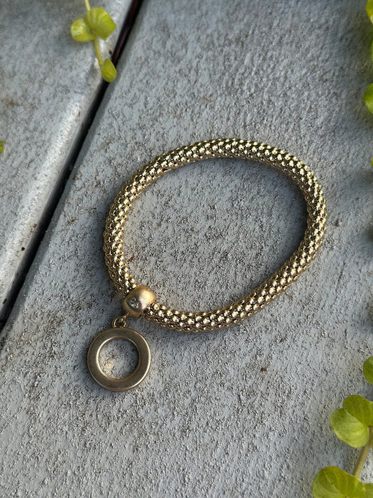 Gold twisted bead bracelet with O-ring charm