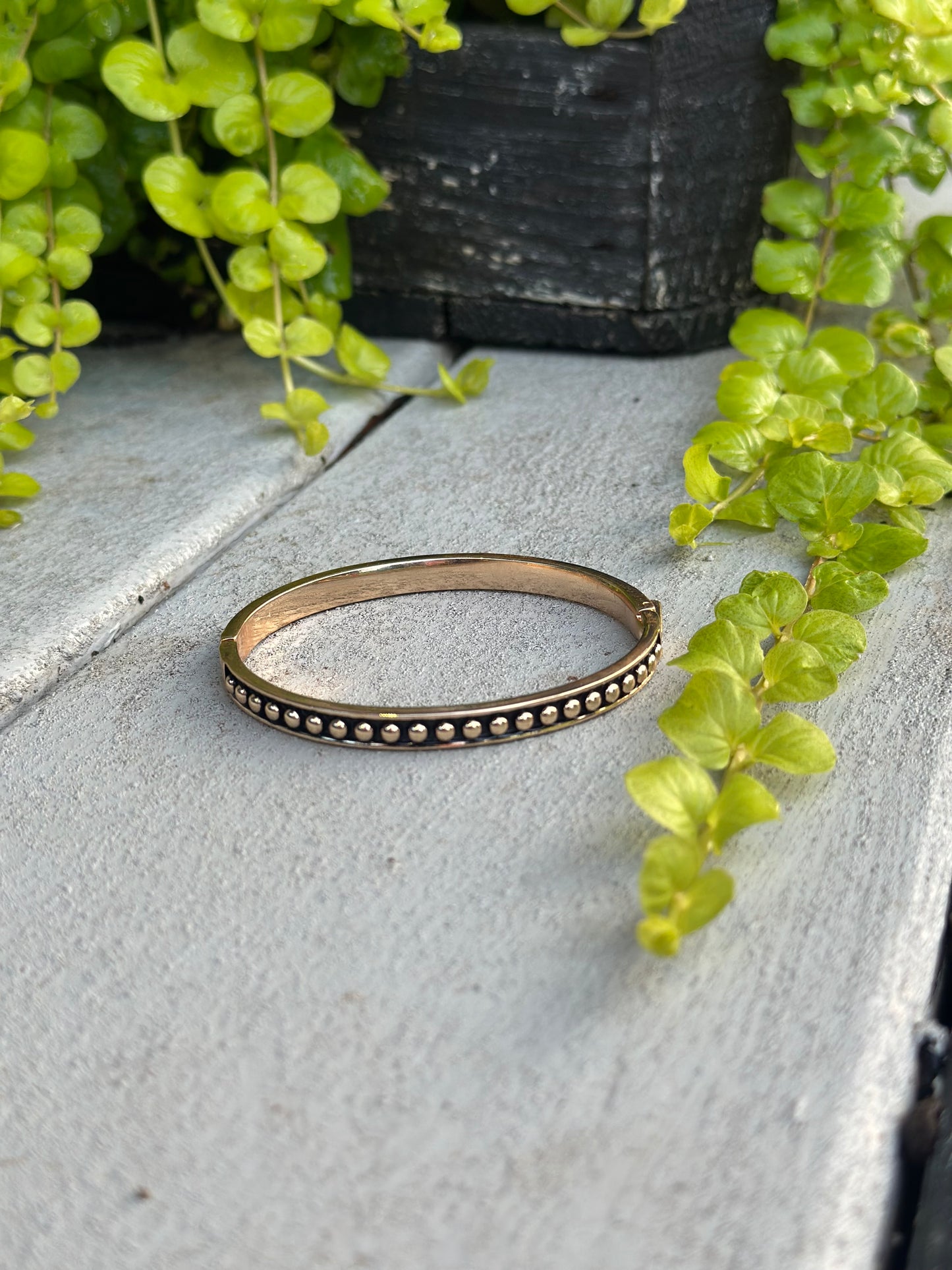 Gold bangle with black and gold bead detail