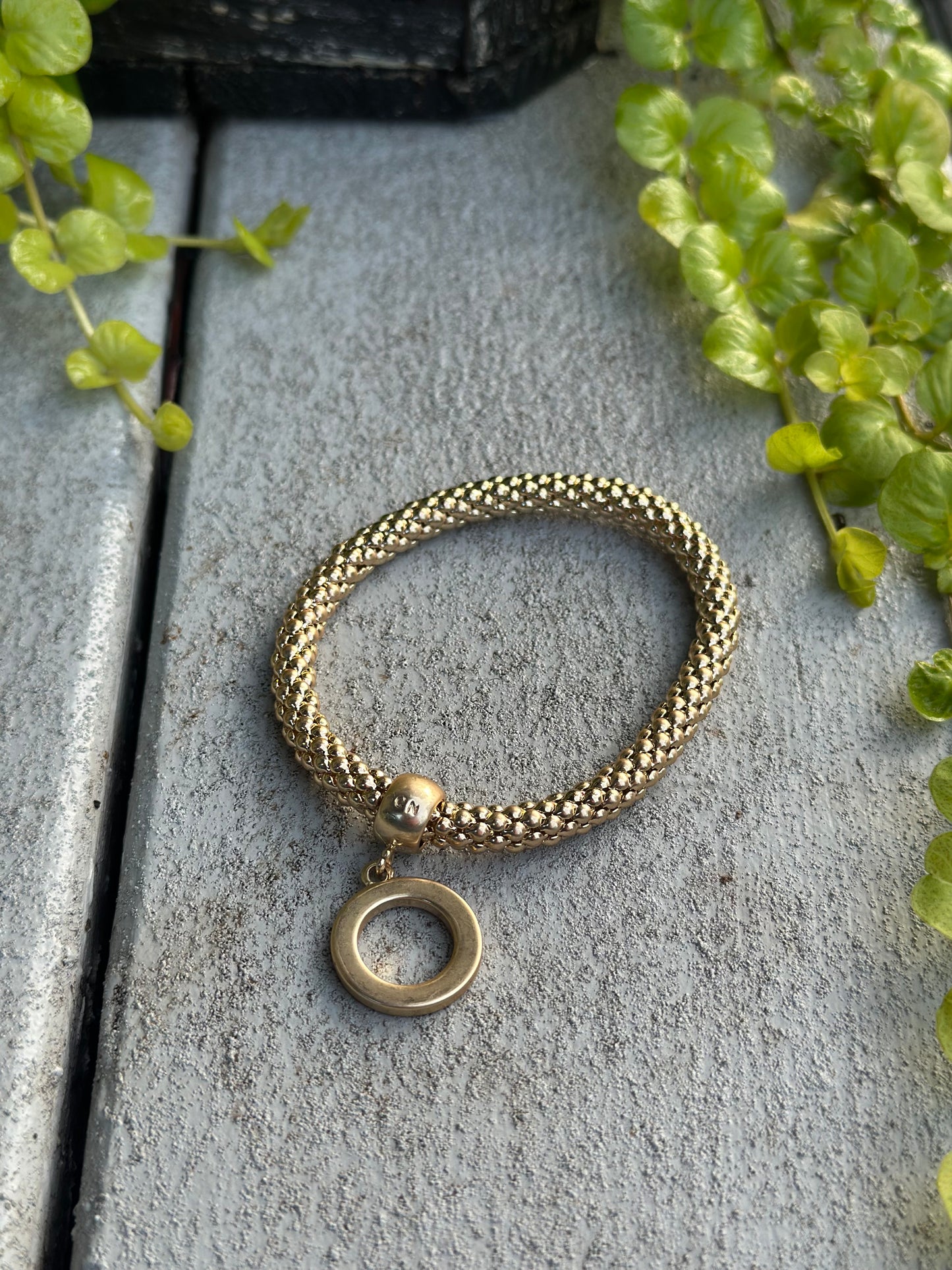 Gold twisted bead bracelet with O-ring charm